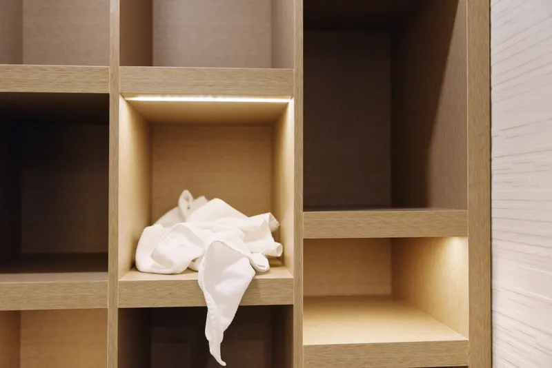 Shelf storage wood cubbies tissue in a compartment highlights organization and minimalist interior design in a warm home setting
