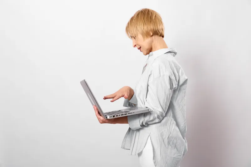 Boy child laptop learning school technology typing studying education white background isolated, kid typing on laptop keyboard with alert expression in studio