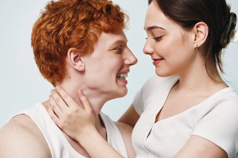Couple, love and intimacy with young woman and man looking at each other smiling in romantic moment. Relationship, affection and close connection for happiness and trust.