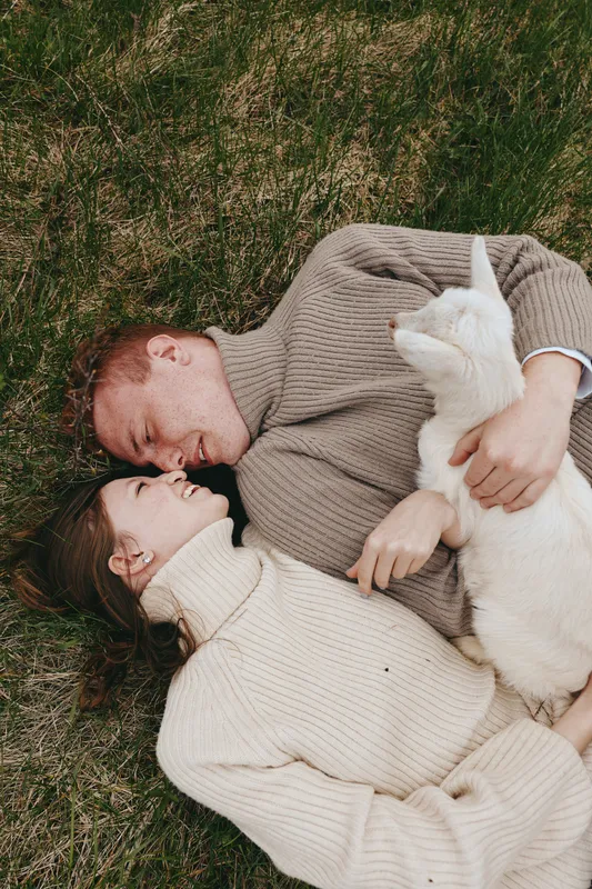 Couple outdoors grass sweater cuddle cat love relax intimate natural, lifestyle, affection, comfort, together, peaceful, moment, nature, companion, partner, warmth, close, tender, ease, family,
