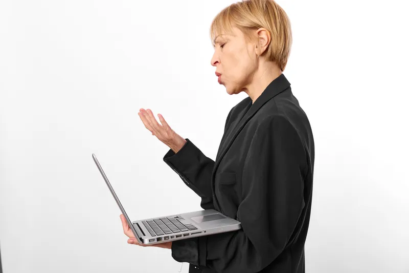 Woman business laptop communication professional profile portrait technology, female manager gestures while speaking, laptop in hand, isolated on white background
