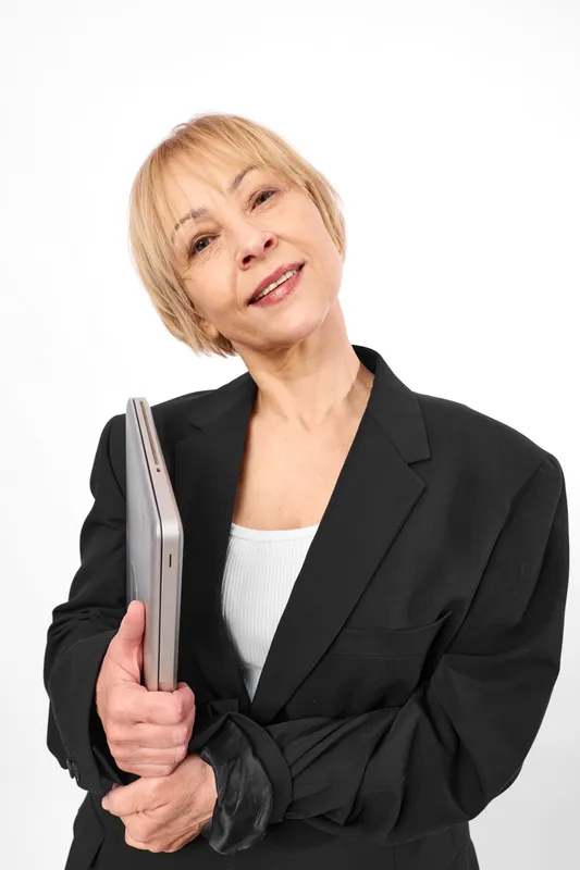 Woman holding electric hair iron, short blond hair, studio portrait on white background, beauty hair styling and wellness, confident mood