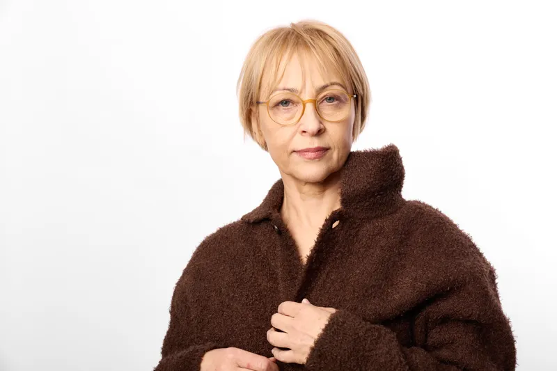 woman elderly glasses fur coat winter portrait on white background, close up view, calm confident expression, soft studio light, cozy warmth, fashion comfort