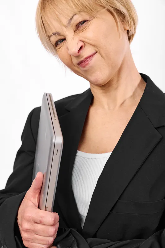 Senior woman holds a tablet for technology education, smile and business blazer portrait, closeup hand holding silver device, isolated on white background