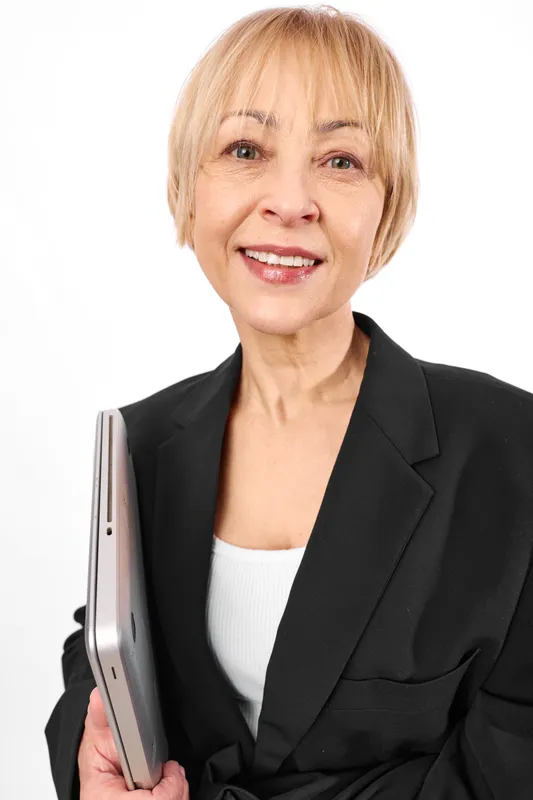 Woman, senior portrait, smiling, holding tablet, technology, communication concept, black blazer, studio background, soft light, friendly expression today