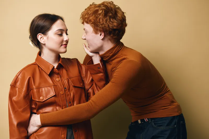 Couple, romance and affection with young man gently touching woman face indoors. Love, connection and tenderness between people with emotional moment and casual clothing style.