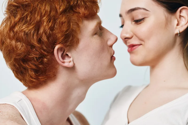 Couple, love and intimacy with affectionate young man and woman close together, expressing emotion and connection in casual clothing with soft lighting.