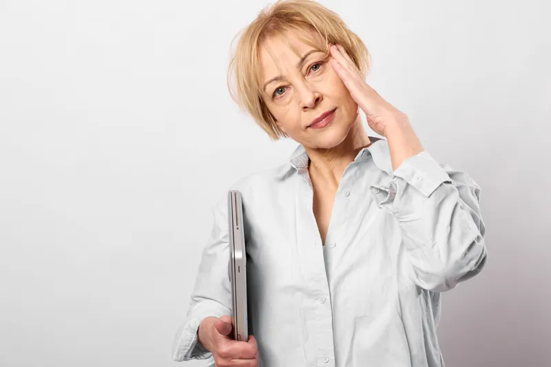 Elderly woman smartphone worried stressed portrait, technology communication concern, hand on forehead, holds phone device, isolated white background, tech support anxiety