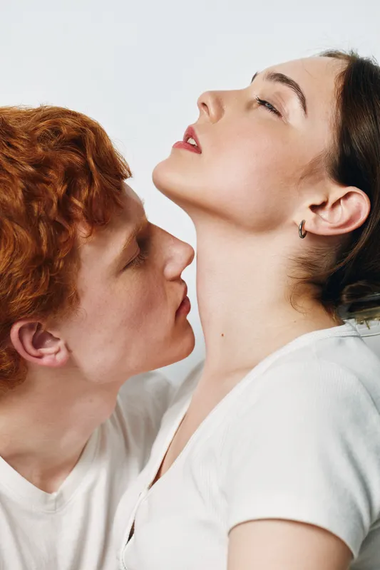 Couple, young man and woman in intimate pose for romance and connection with skin contact in studio. Love, affection and relationship between two people with tenderness and trust.
