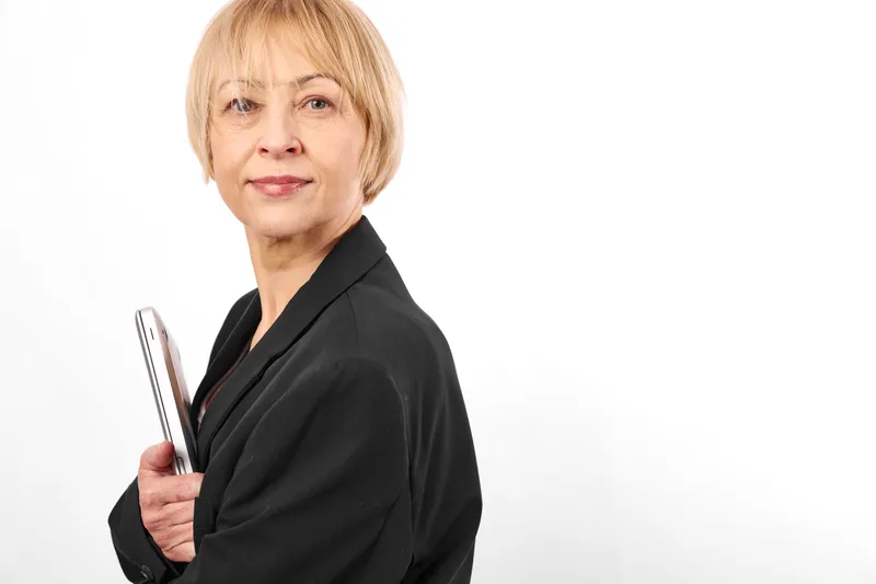Woman portrait, blonde hair, business suit, holding pen, confident attitude, adult professional on white background, studio headshot, neutral expression, copy space for text