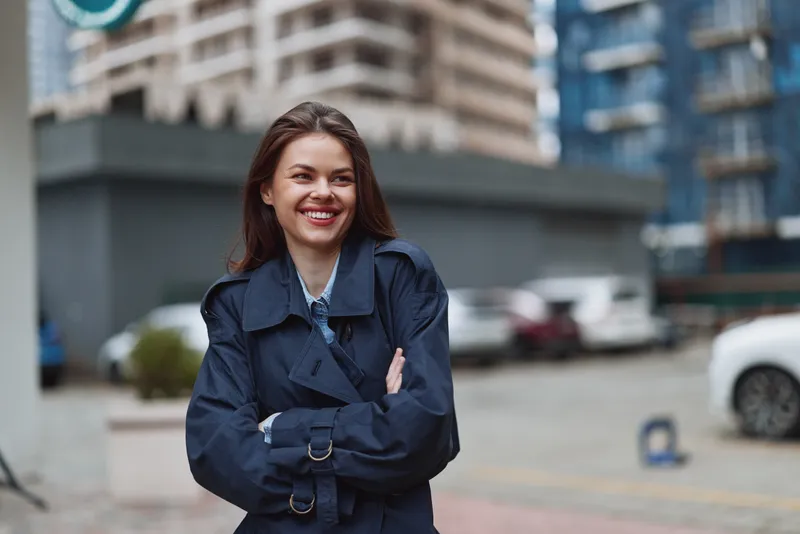 Woman smiling outdoor urban jacket portrait street fashion casual cheerful, a confident candid portrayal on a modern city backdrop exuding charm and positive vibe