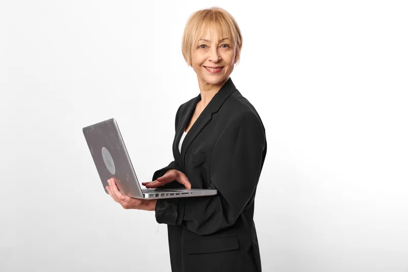 Woman business portrait smiling suit clipboard tablet studio white senior, executive holding clipboard, corporate consulting, confident communication in studio background