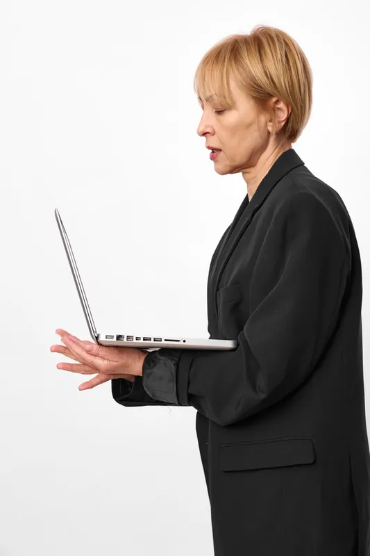 Businesswoman in profile holding a pen and pointing at a tablet on a plain light background, business work communication, modern office concept, focused calm mood, studio lighting