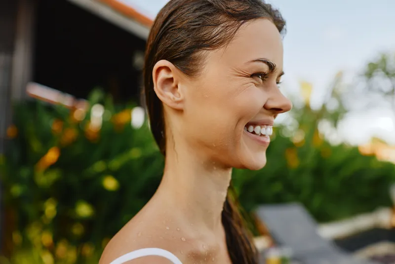 woman smile outdoors sun summer portrait happiness greenery leisure lifestyle, joyful moment outdoors with a smiling woman by lush garden, warm breeze, natural colors, candid and vibrant lifestyle