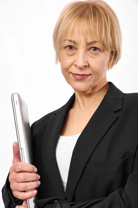 Senior woman business portrait in studio holding tablet, confident professional, technology and communication concept on clean white background portrait