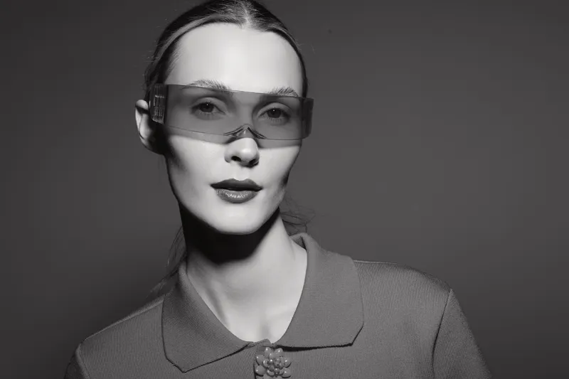 Portrait of a fair skinned white woman wearing futuristic glasses in a monochrome studio. Concept for fashion, technology, and modern style.