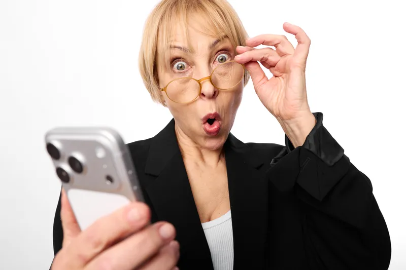 Woman, older, surprised, glasses, smartphone, phone, portrait, studio, white, background, shocked woman holding smartphone, indoors, wide eyes, communication and technology concept