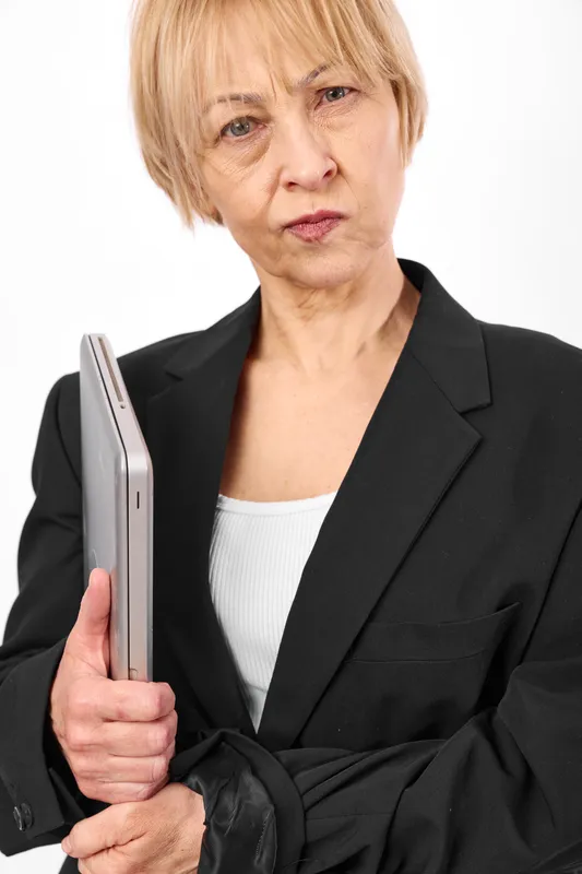 elderly woman business suit smartphone stressed concerned portrait, she grips the device with anxious expression, isolated white background, concept for worry