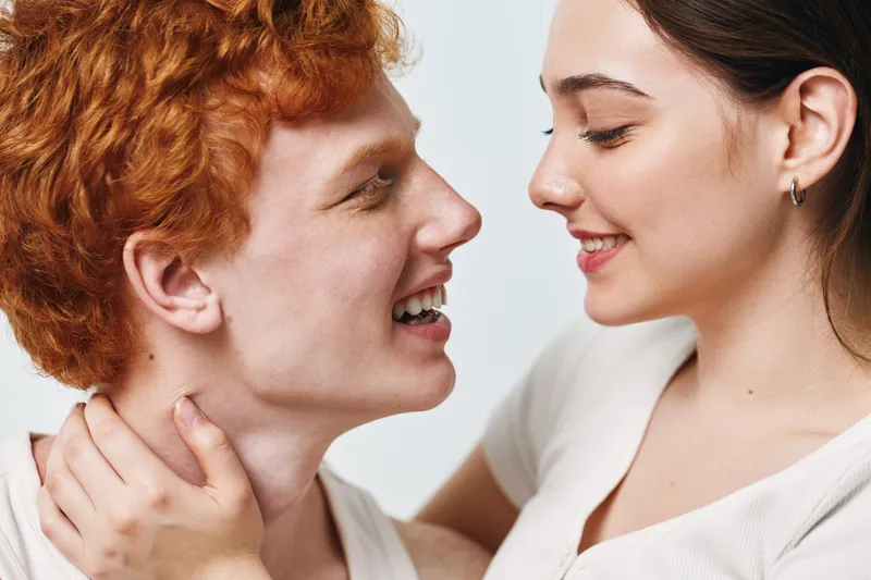 Couple, love, young, happiness, closeup, face, smile, affection, relationship, togetherness. Young couple smiling and embracing with affection and joy in closeup portrait for love and happiness.