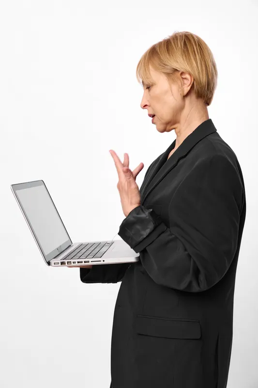 Woman business laptop gesture communication consulting concern office, blonde professional with laptop, speaking hand gesture, serious face, isolated on white background
