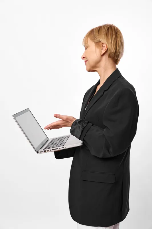 Business woman in black suit with laptop in office profile, hands on keyboard, technology and communication for work, focused, isolated on white background, clean copy space