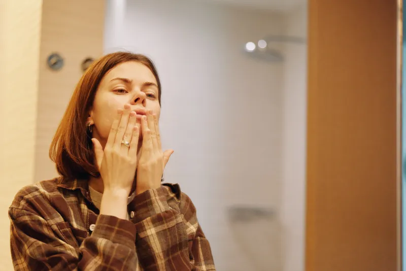Woman, kiss, blowing gesture, portrait of a casual female in a plaid shirt inside an office, conveying friendly warmth and playful greeting for lifestyle stock.