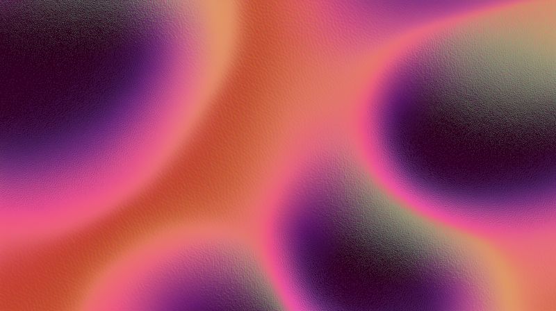 Abstract colorful grainy texture with soft gradient blobs in warm orange, pink and purple tones, creating a dreamy atmospheric background for creative and digital projects.