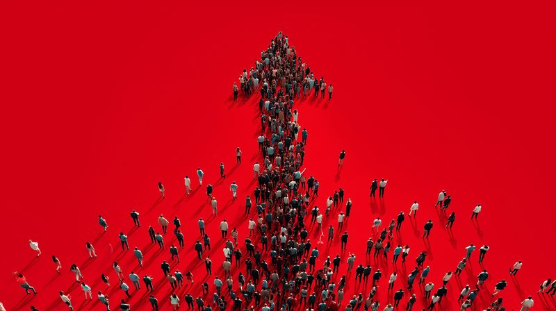 arrow crowd direction leadership teamwork movement unity growth composed of people forming an upward arrow on red background symbolizing progress collaboration navigation success and ambition