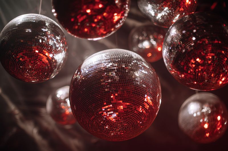 disco ball mirror red party reflection hanging sequined spheres in nightclub lighting for celebration decor festive dancefloor atmosphere sparkle glow